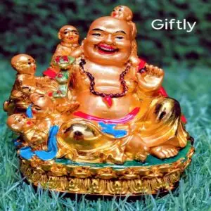 Golden Laughing Buddha idol with children – Giftly decor product placed on green grass background
